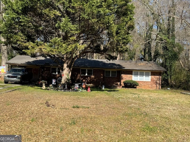 ranch-style home with a carport, a front yard, and brick siding