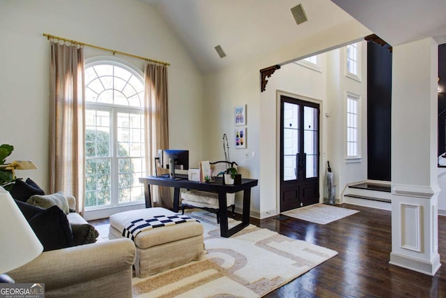 entrance foyer featuring dark wood-type flooring and high vaulted ceiling