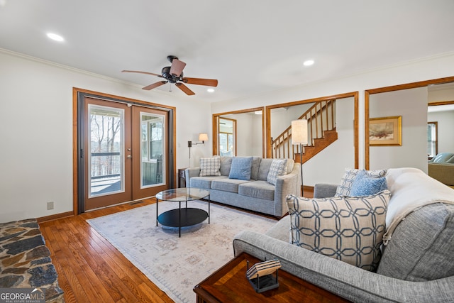 living area featuring hardwood / wood-style flooring, recessed lighting, stairway, and french doors