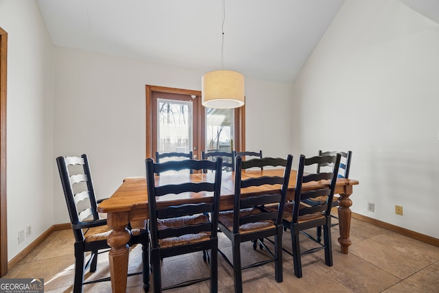 dining space with lofted ceiling and baseboards