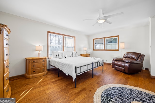 bedroom featuring crown molding, ceiling fan, light wood finished floors, and baseboards