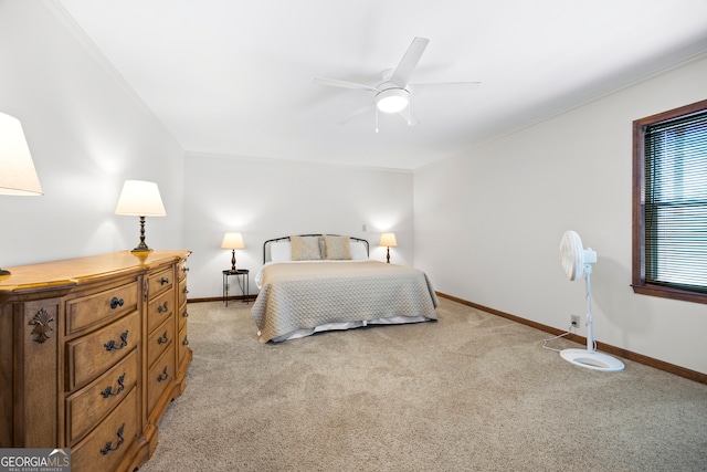 bedroom featuring light colored carpet, crown molding, and baseboards