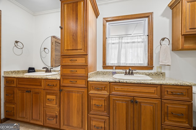 bathroom featuring double vanity, ornamental molding, and a sink