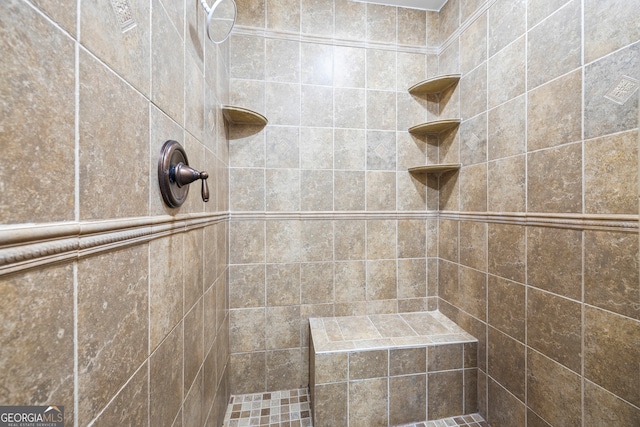 full bath featuring tiled shower