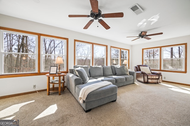 carpeted living area with baseboards and visible vents