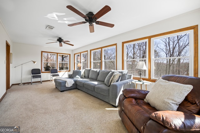 living room with carpet floors, visible vents, and baseboards