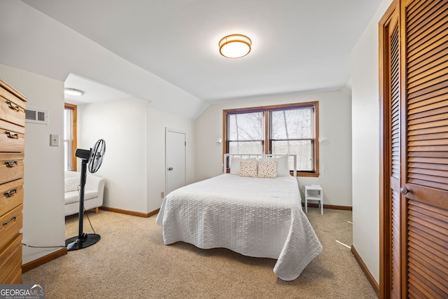 bedroom featuring light carpet, baseboards, visible vents, and a closet