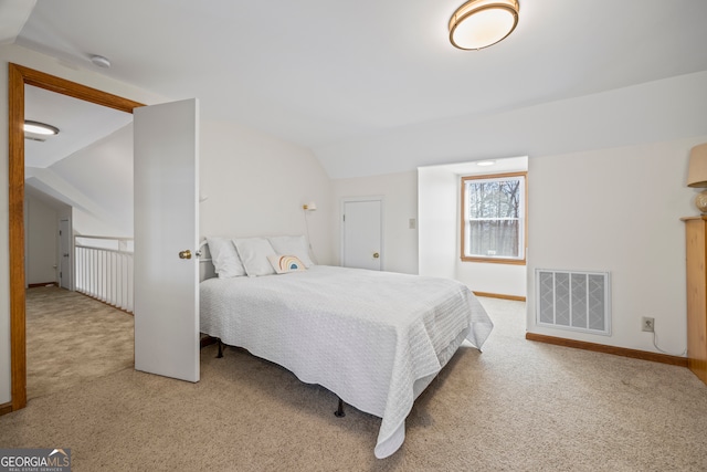 bedroom with lofted ceiling, baseboards, visible vents, and carpet flooring