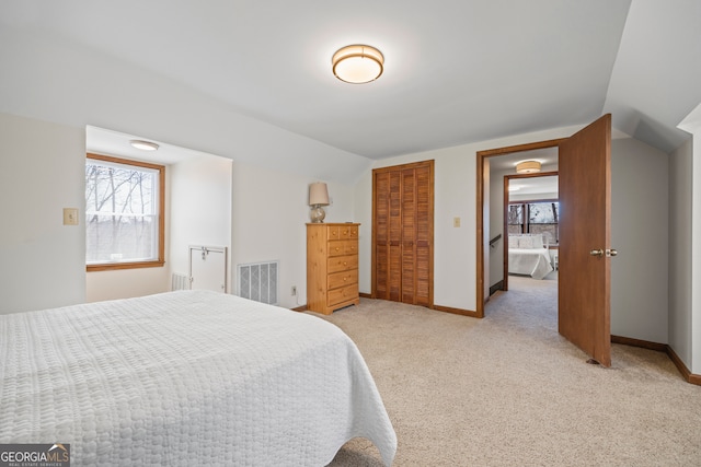 bedroom with vaulted ceiling, multiple windows, and baseboards