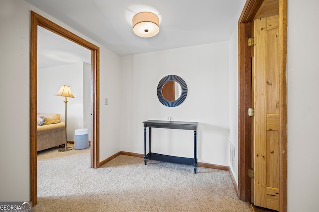 hall with carpet and baseboards