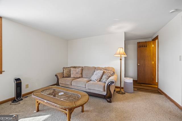 carpeted living area with baseboards