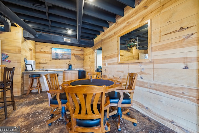 dining space featuring wooden walls and visible vents