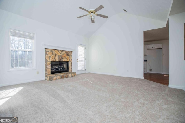 unfurnished living room with ceiling fan, high vaulted ceiling, a fireplace, carpet flooring, and baseboards