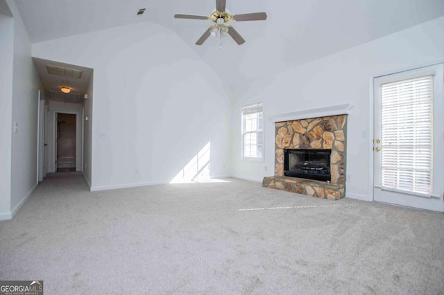 unfurnished living room featuring a fireplace, vaulted ceiling, visible vents, and carpet flooring