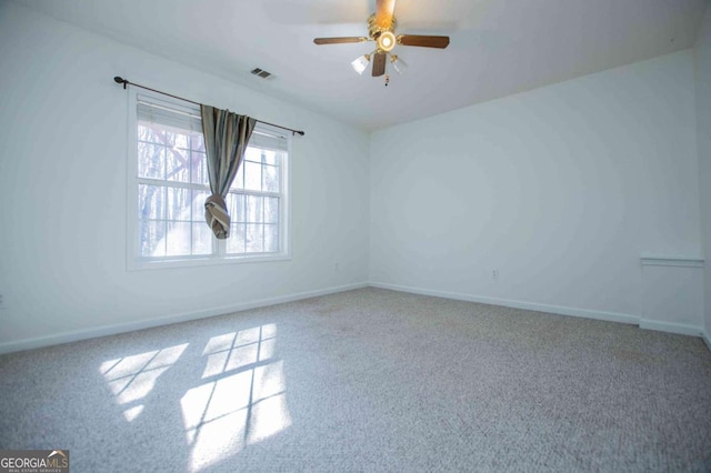 empty room featuring carpet floors, ceiling fan, visible vents, and baseboards