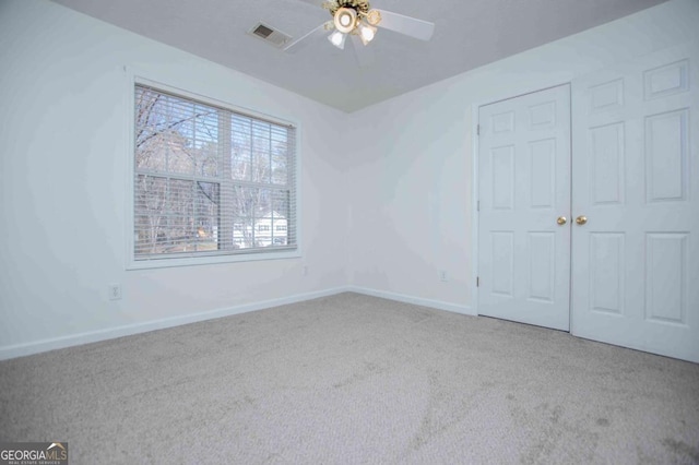 unfurnished bedroom featuring ceiling fan, carpet floors, visible vents, and baseboards