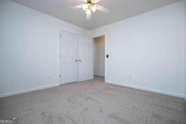 unfurnished bedroom featuring carpet flooring, ceiling fan, and baseboards