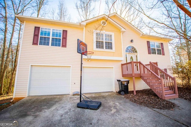 raised ranch featuring a garage and driveway