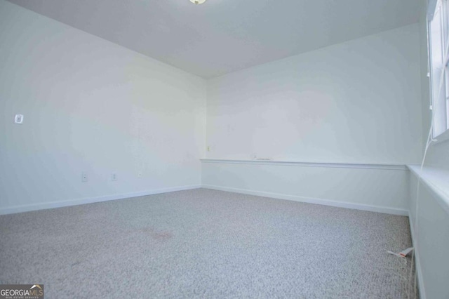 empty room with carpet floors and baseboards