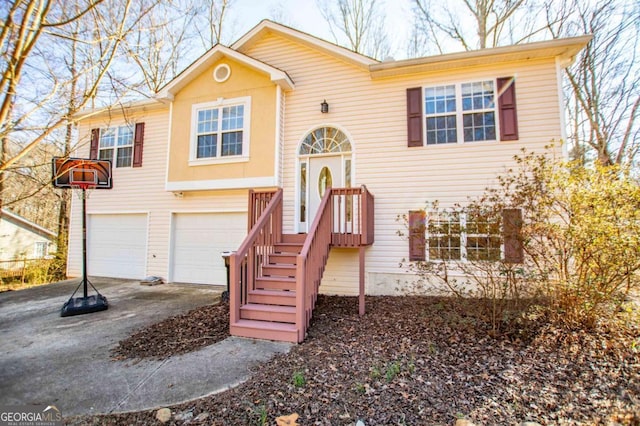 split foyer home featuring driveway and a garage