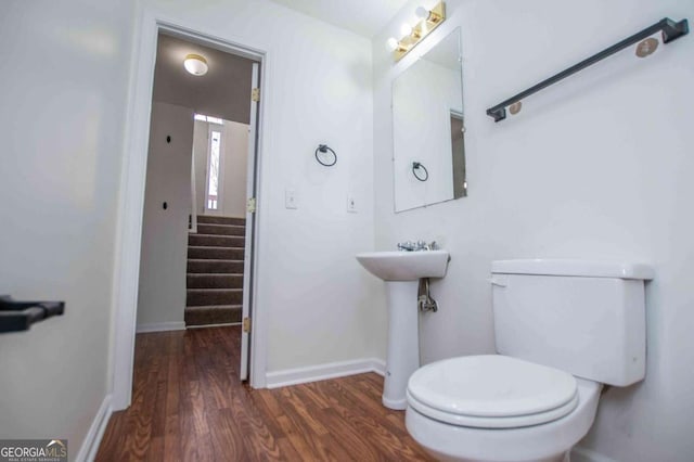 bathroom featuring baseboards, toilet, and wood finished floors