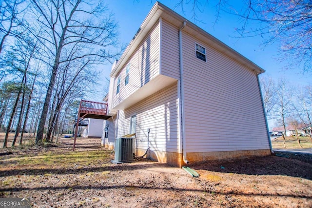 view of side of home with central AC