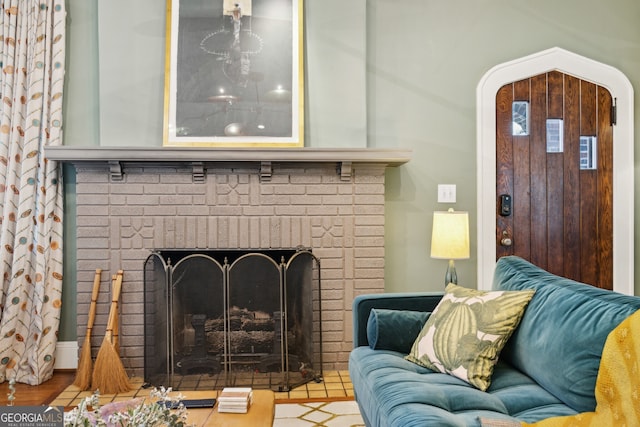 living room featuring arched walkways and a brick fireplace