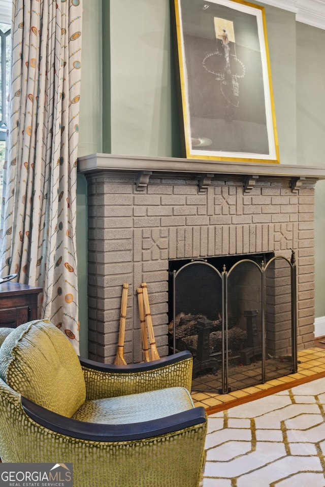 room details featuring ornamental molding and a brick fireplace