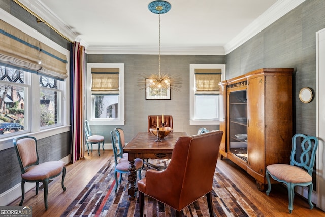 dining area featuring a wealth of natural light, crown molding, and wood finished floors