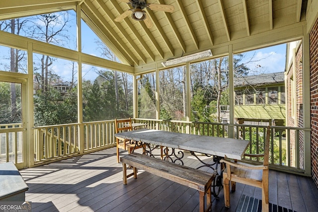 sunroom / solarium with ceiling fan and lofted ceiling with beams