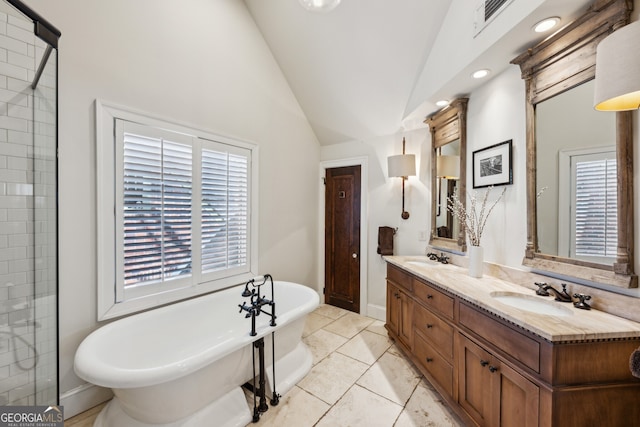 full bathroom featuring double vanity, a soaking tub, vaulted ceiling, a sink, and plenty of natural light