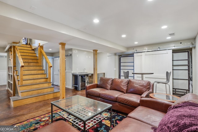 living room with a barn door, recessed lighting, beverage cooler, indoor bar, and stairway