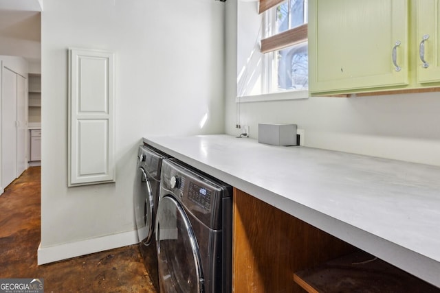 washroom with cabinet space and independent washer and dryer