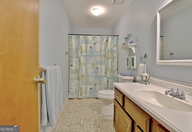 bathroom featuring toilet, curtained shower, tile patterned flooring, and vanity