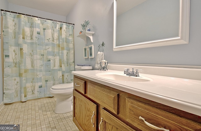 bathroom with curtained shower, vanity, toilet, and tile patterned floors