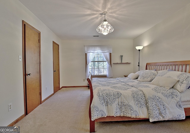 carpeted bedroom featuring visible vents and baseboards