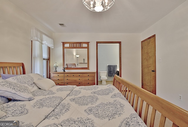 bedroom with an inviting chandelier and visible vents