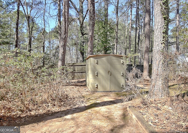 view of shed with fence