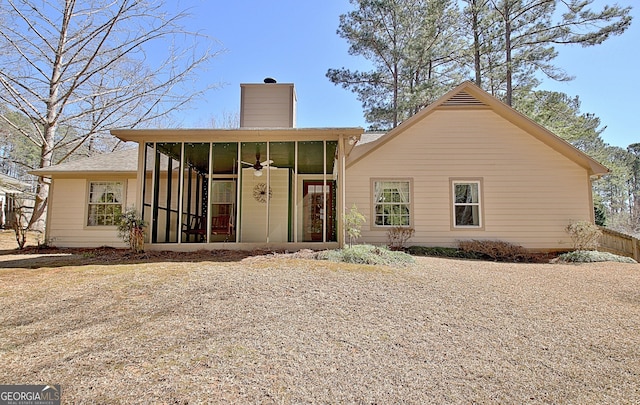 view of front of house with a sunroom and a chimney