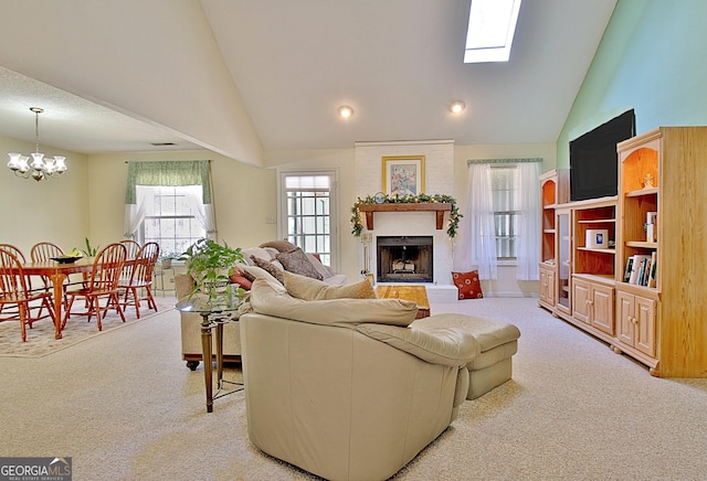 living room featuring high vaulted ceiling, carpet, a brick fireplace, and a notable chandelier