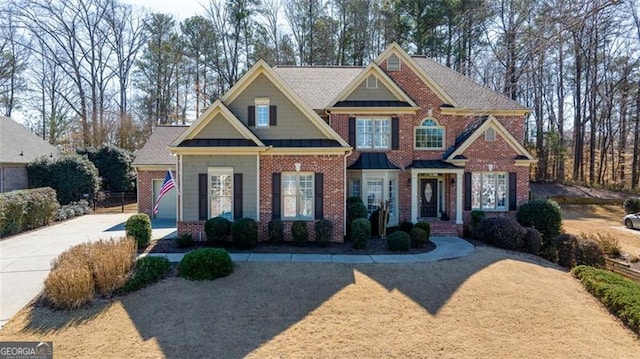 craftsman inspired home with driveway and brick siding