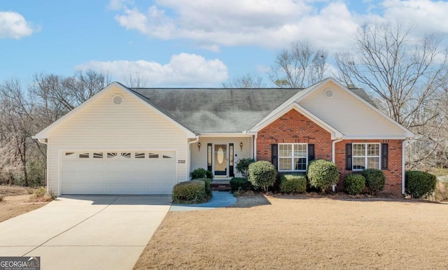 ranch-style house with a garage, driveway, and brick siding