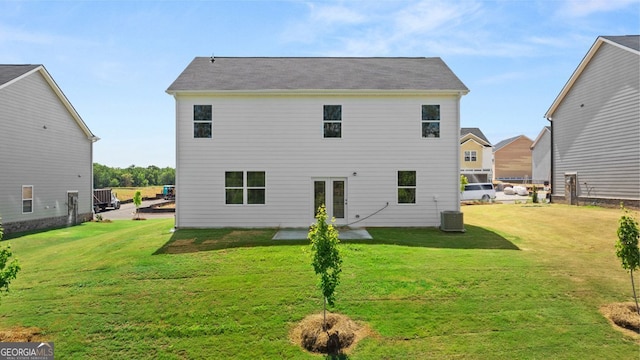 rear view of property with french doors, a lawn, a patio area, and central air condition unit