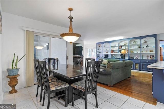 dining area with light tile patterned floors and built in shelves