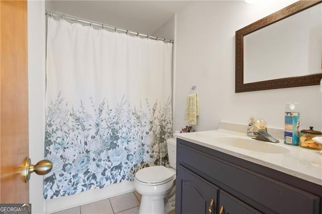 bathroom with tile patterned flooring, a shower with curtain, vanity, and toilet