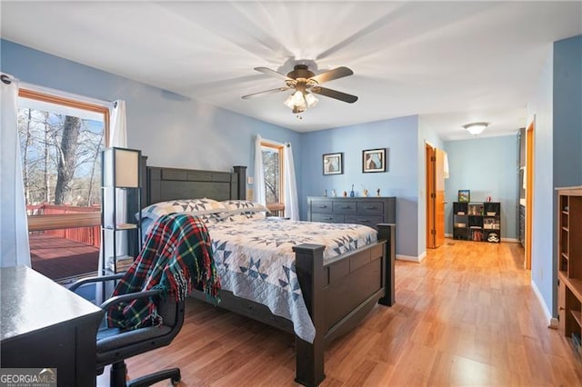 bedroom featuring light wood-type flooring, a ceiling fan, and baseboards