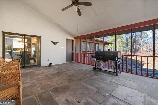 sunroom with lofted ceiling and ceiling fan