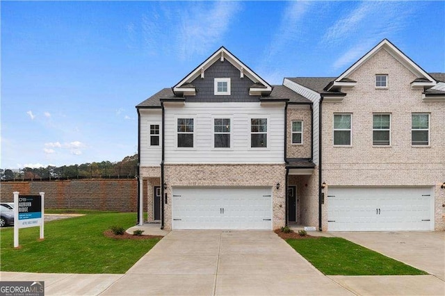 townhome / multi-family property featuring an attached garage, a front lawn, concrete driveway, and brick siding