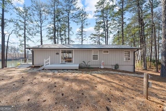 rear view of property featuring a wooden deck