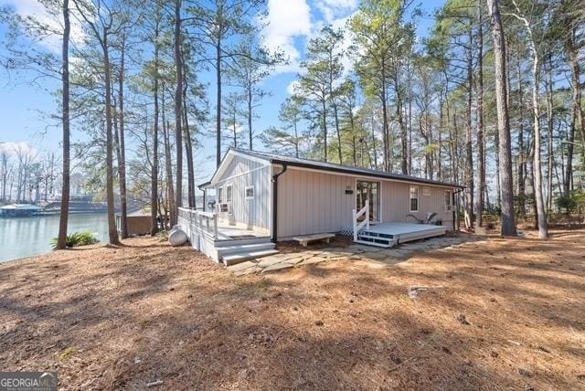 view of front of house with a deck with water view